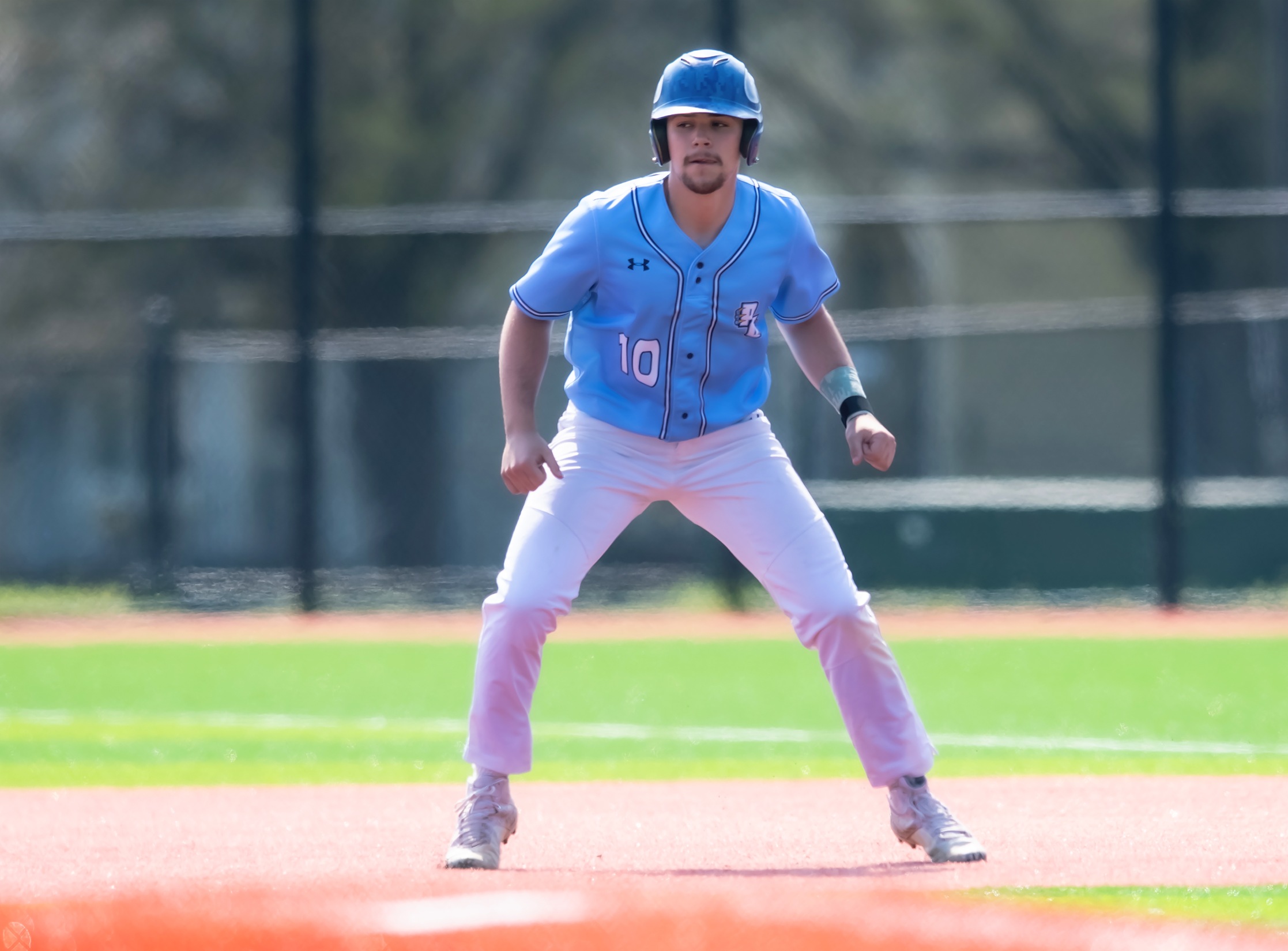 Sophomore Grayson Lewis (10) reads the pitcher as he takes a lead at first base during a game against the College of Southern Maryland on April 8th, 2021.